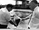Councilman Sinkiewicz and John Pilch examining a cloth dipped in the Cuyahoga River by Paul Tepley