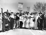 Women waving and holding "Votes for Women" signs by unknown