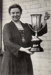 Belle Sherwin holds the silver loving cup by unknown
